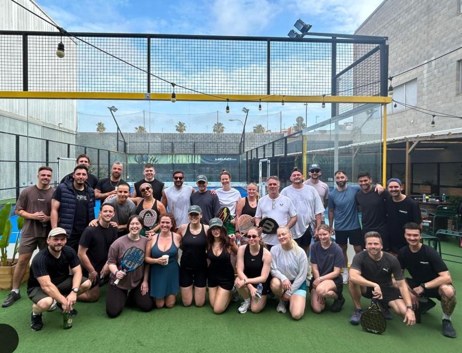 Club members gathered courtside after a padel session